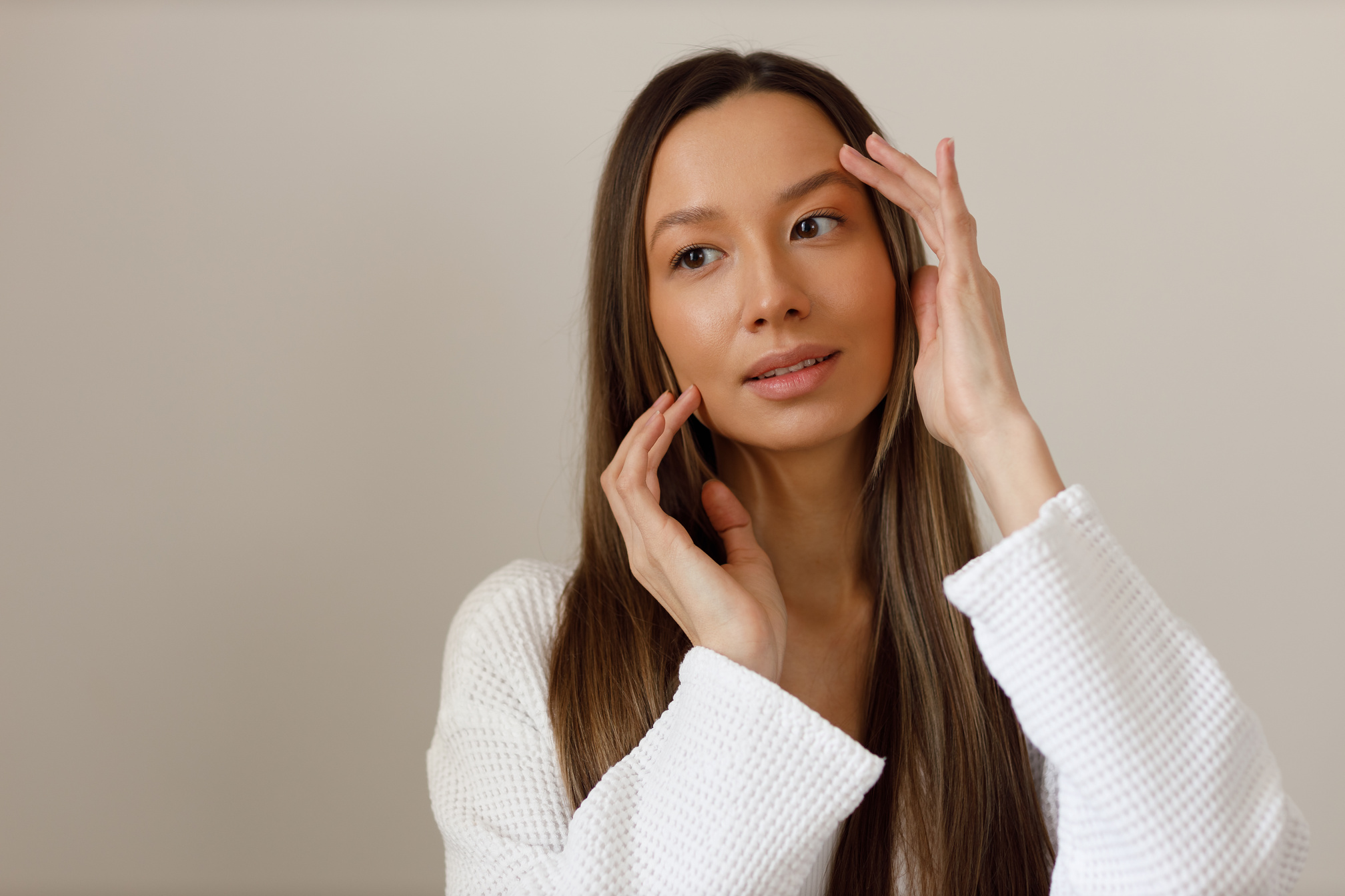 Young multiracial woman doing face building yoga and facial gymnastics self massage and rejuvenating exercises procedure